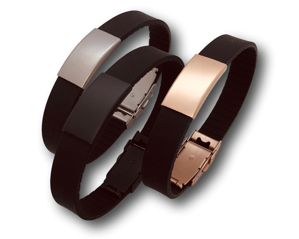 Three black silicone bracelets each with a different coloured metal faceplate and clasp.