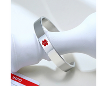 Load image into Gallery viewer, Silver medical alert bracelet with red enamel medical symbol on front.

